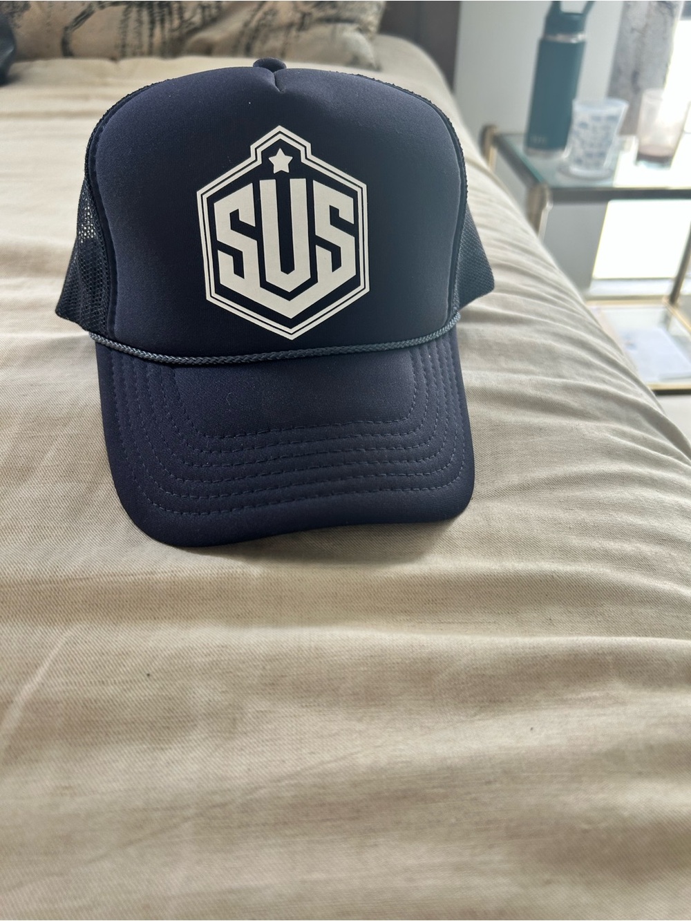 Unisex “SUS” Navy Trucker Hat with White Logo